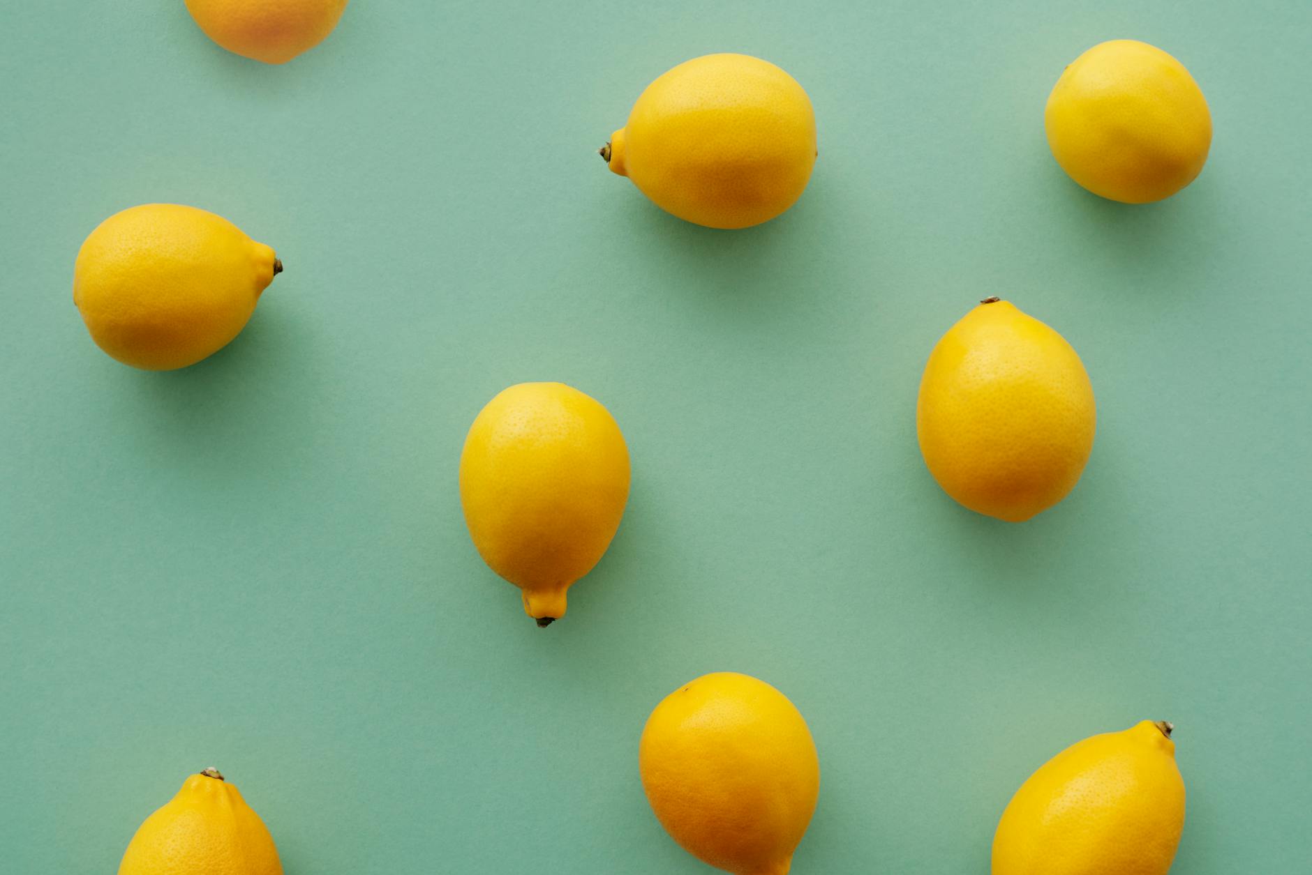 Bright yellow lemons on pastel background symbolizing renewal and sensory awakening