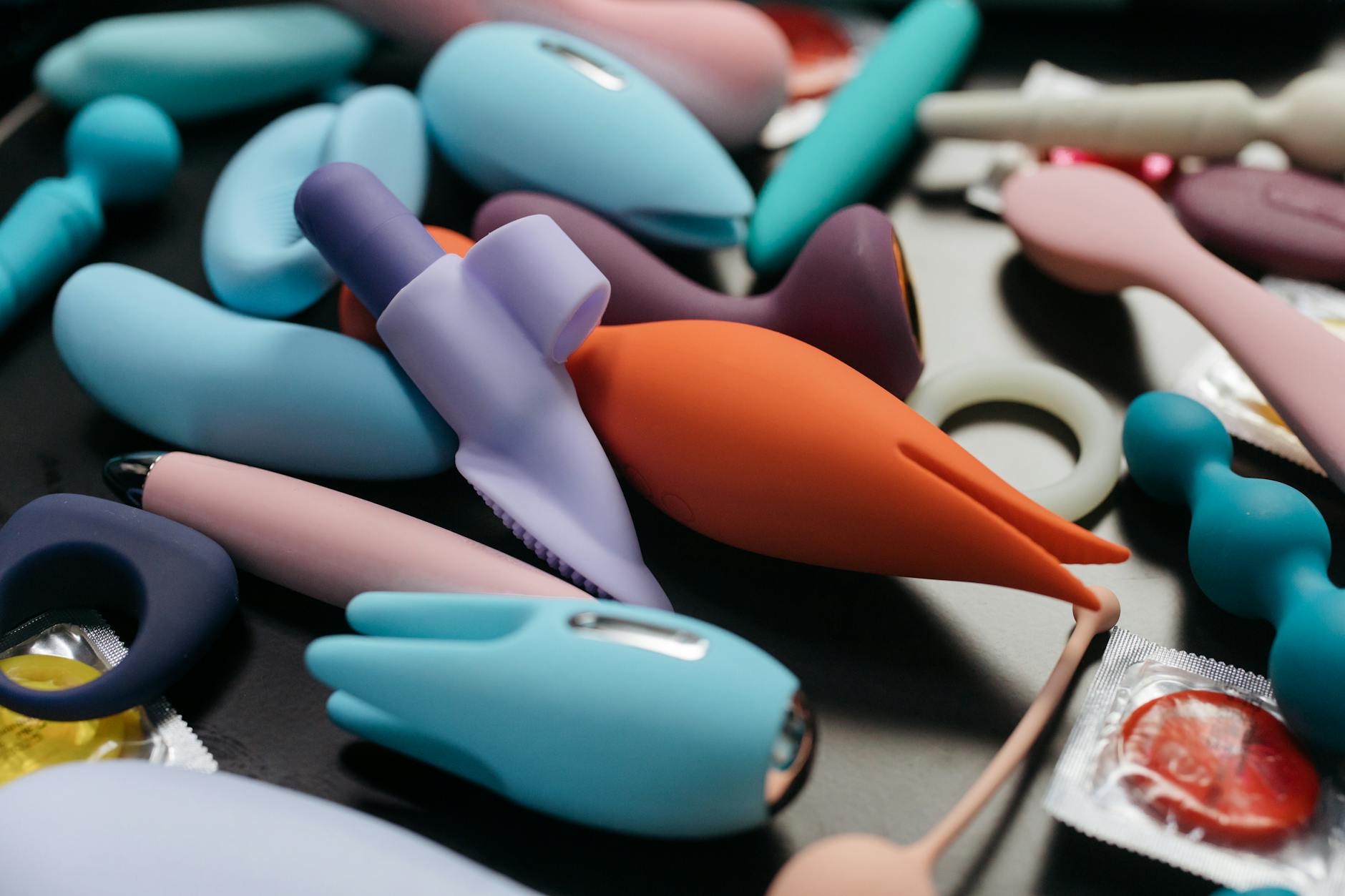 A collection of vibrant lemon adult toys and intimate devices arranged closely together, representing diverse options for couples reconnecting.